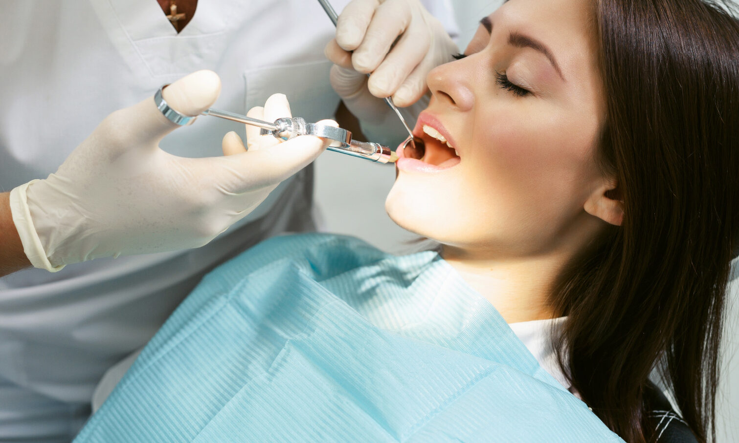 Woman having dental extraction