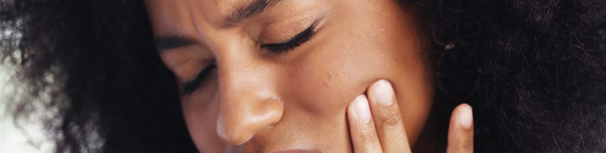 Toothache, sad and face of African woman at home for dental decay, poor oral hygiene and gum health pain. Gingivitis, bad breath and cavity bacteria with person for inflammation, tmj and crisis.